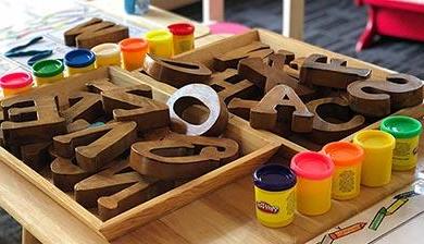 橡皮泥和木制字母盒子在桌子上